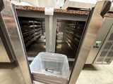 an image of a kitchen with a trash can in the middle of the floor