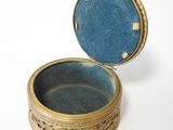 a small box with a blue lid sitting on a white surface