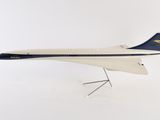 a model of a plane on a stand on a white surface