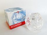 a box of snowballs sitting next to a glass ball