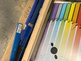 a wooden box with a bunch of different colored papers in it