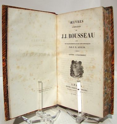 un livre ouvert posé sur une table, avec une bougie dessus
