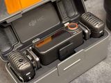 two walkie talkies in a case on a table
