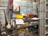 a metal workbench with tools on it in a garage
