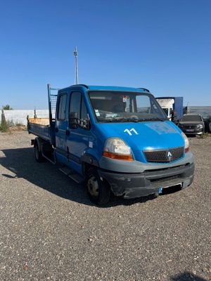 a blue truck that is parked in a parking lot