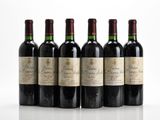 six bottles of red wine lined up in a row on a white surface