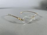 glasses on a table with a white table cloth and a cell phone