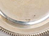 a silver plate on a table with a white table cloth