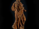 a wooden statue of a woman holding a child