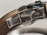a close up of a watch on a white surface