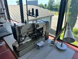 a sewing machine sitting on a table in front of a window