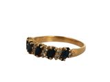 a close up of a gold ring with black and white stones