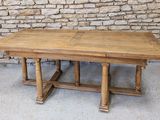 an image of a wooden table sitting in front of a stone wall
