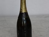 a bottle of champagne sitting on a marble table