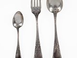 three spoons and a fork on a white surface