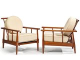 pair of mid - century danish lounge chairs with upholstered cushions