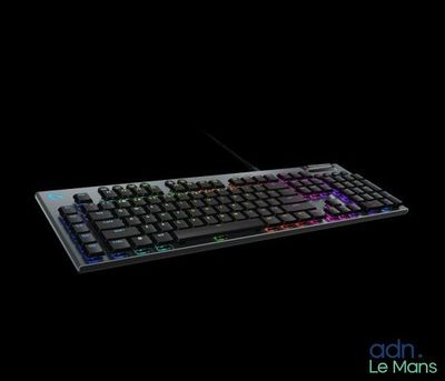 a computer keyboard that is lit up in the dark