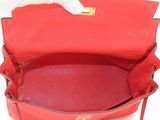 the inside of a red purse with a tissue in it