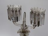 a glass candelab with a candle holder on it