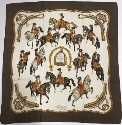 un gros plan sur un foulard carré orné de chevaux et de cavaliers
