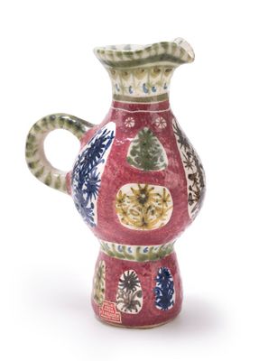 a red vase with a blue and green design on it