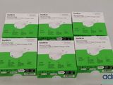 a group of four boxes of green batteries sitting on top of a white table