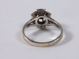 a close up of a ring with a diamond on it