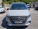 a silver mercedes van parked in a parking lot