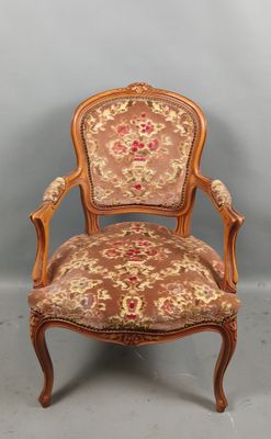 une chaise en bois recouverte d'un tissu à motifs floraux, recouverte, recouverte, recouverte, recouverte, recouverte