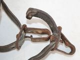 a pair of old rusty horseshoes on a white surface