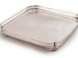 a silver tray with a handle and handles on a white background