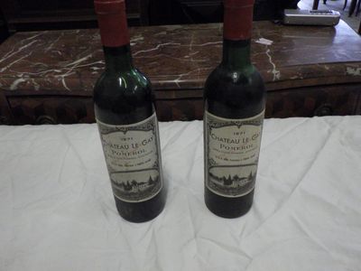 two bottles of wine that are sitting on a table