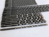 many different types of drill bits laid out on the table