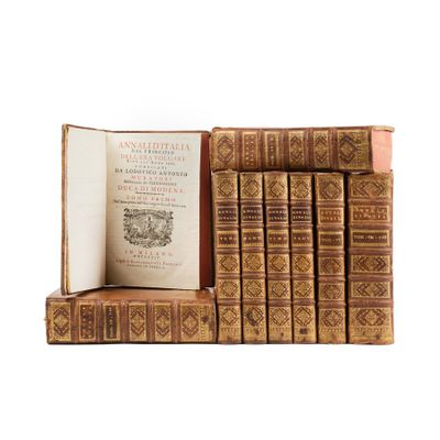 several books are stacked on top of each other on a white surface