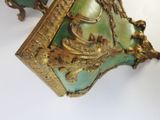 two green vases with gold decorations on them