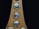 a wooden plaque with pictures on it on a black background