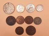 several different coins are arranged in a row on a table