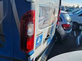 many cars parked in a parking lot next to each other