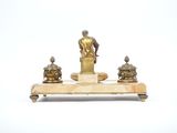 a statue of a man sitting on top of a table