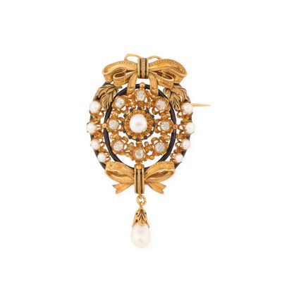 a close up of a brooch with pearls and leaves