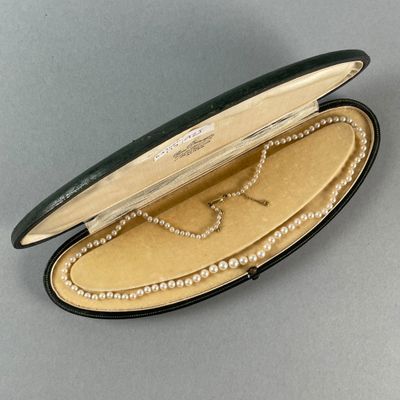 a black case with pearls inside of it on a table