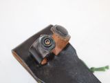 a black skateboard with a brown leather strap on it
