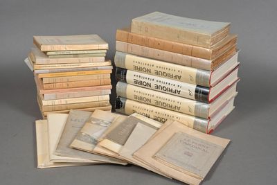 several old books stacked on top of each other on a table