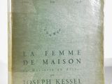 an old book sitting on top of a table next to a white wall