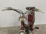 a red motorcycle that is parked on the carpet