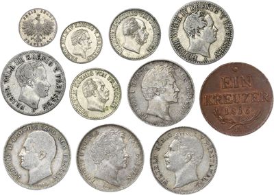 a close up of a bunch of coins on a white surface