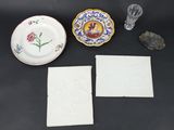three plates, a glass vase, and a napkin are on a table