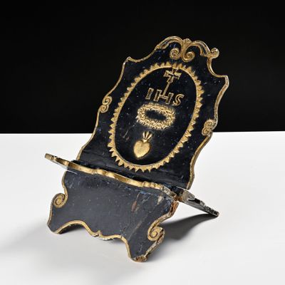 an old black and gold clock with a clock face on it
