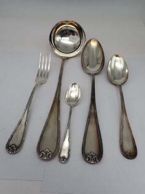 five silver spoons and two silver spoons on the table