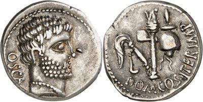 a silver coin with a skull and a sword on it